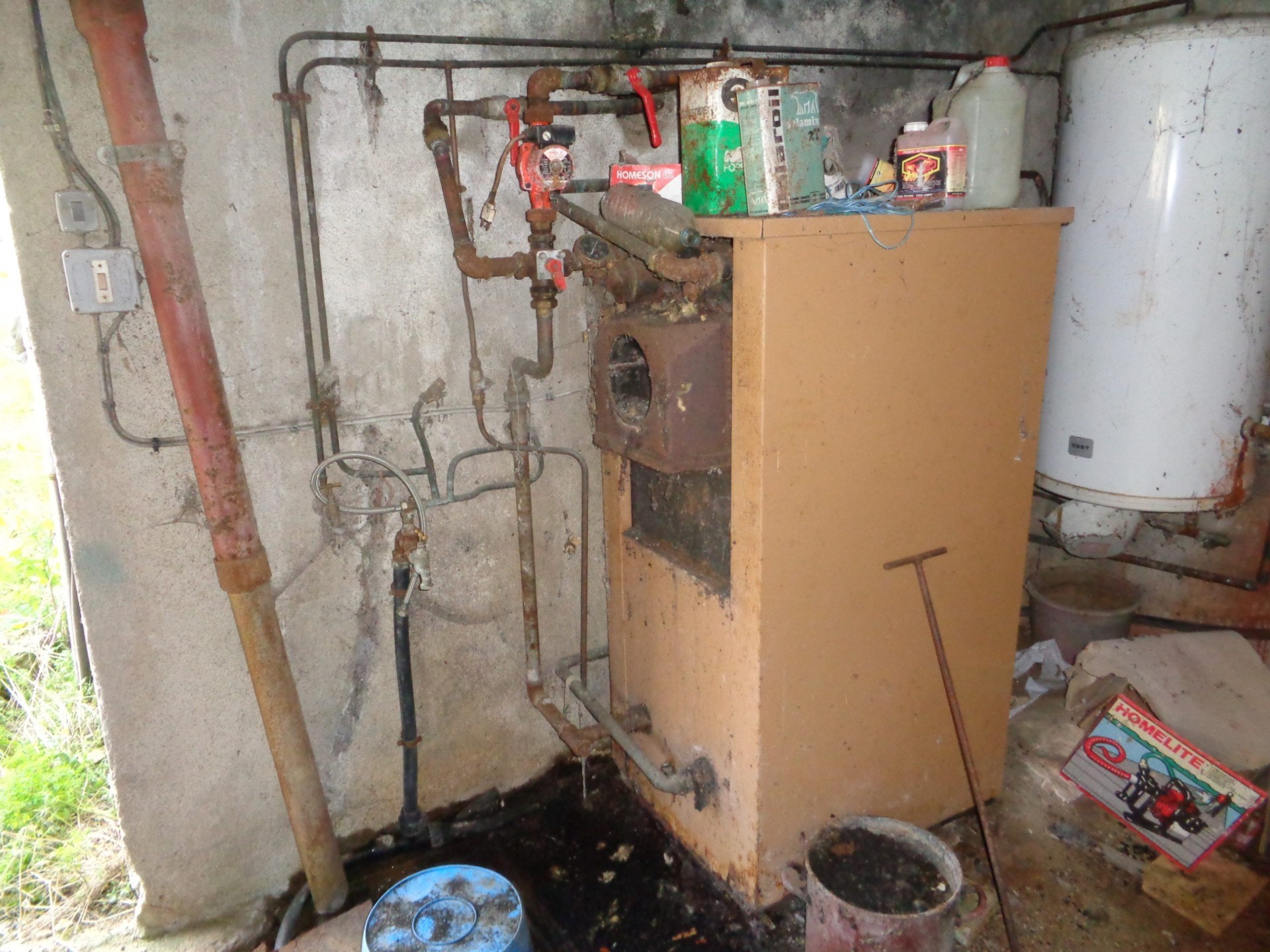 Water Tap is to the Left of Rusty Boiler